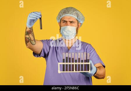 Epidemic threshold. Critical number or density of susceptible hosts. Man in medical lab inspecting samples biological material. Epidemic disease Stock Photo