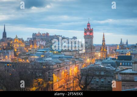 Cityscape night view from Calton Hill of illuminated Edinburgh old town skyline, Princes Street, Balmoral Clock Tower and Edinburgh Castle in the capi Stock Photo