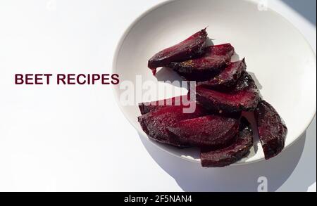 Beet slices on a white plate. Copy space. Stock Photo