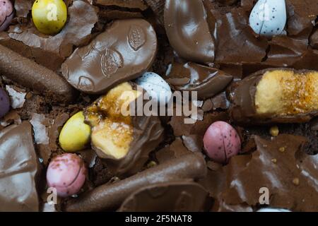Home baking Easter concept. Brownie with chocolate bars, mini easter eggs and biscuits baked in. Chocolate feast home baked treat Stock Photo