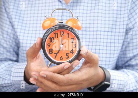 man hand holding alarm clock close up  Stock Photo