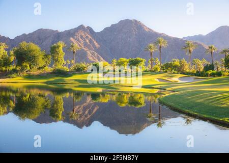 Beautiful golden light over Indian Wells Golf Resort, a desert golf course in Palm Springs, California, USA with view of the San Bernadino Mountains. Stock Photo