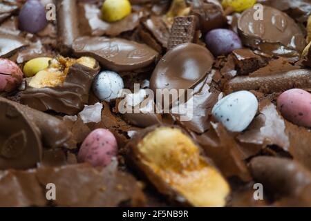 Home baking Easter concept. Brownie with chocolate bars, mini easter eggs and biscuits baked in. Chocolate feast home baked treat Stock Photo