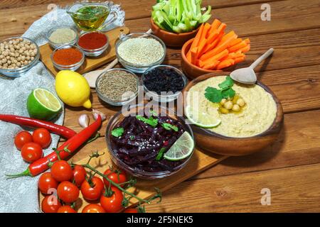 Hummus.Set of products and spices for cooking. Background on wooden Board. Middle Eastern cuisine. Stock Photo
