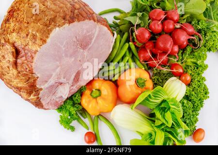 Glazed pork ham with fresh vegetables. Healthy food. Stock Photo