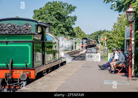 SECR 'H' 0-4-4T No. 263 waits for BR 'Q' 0-6-0 No. 30541 to arrive at Sheffield Park on the Bluebell Railway, West Sussex Stock Photo