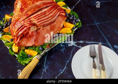 Delicious honey smoked pork ham with table setting. Stock Photo