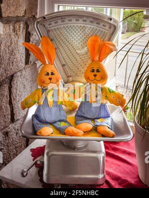 Two Easter bunnies on an old weighing machine Stock Photo