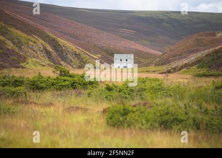 An old abandoned mining site, Lecht Mine, in the rolling hills countryisde landsacpe of Cairngorms National Park, in the Scottish Highlands of Scotlan Stock Photo