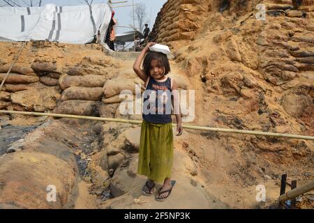 A child seating on open sky after a huge fire swept through a Rohingya refugee camp in southern Bangladesh on Monday, destroying thousands of homes an Stock Photo