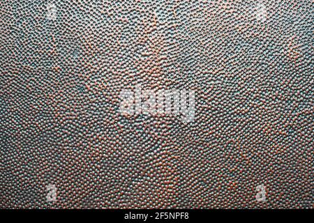 Detail of perforated copper metal sheet. Copper checker board with black holes. Rusty old perforated metal plate material surface texture background. Stock Photo