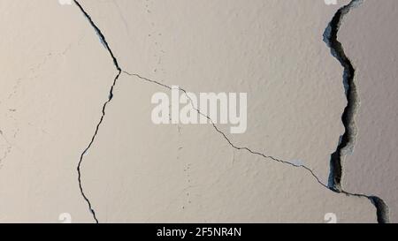 Corrosion in concrete creates a cracked and damaged wall Stock Photo