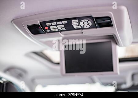 screen m multimedia system control panel on the ceiling of a modern car. close-up Stock Photo