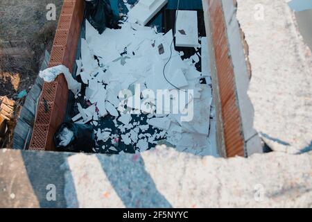 Polystyrene waste on the roof left by the workers who rebuilt the roof of the building Stock Photo