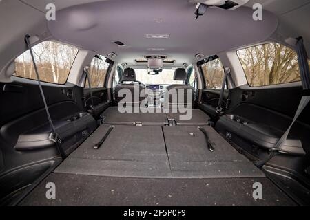 rear view open car trunk with folded passenger seats. large empty flat flor car trunk close up. huge suv trunk Stock Photo