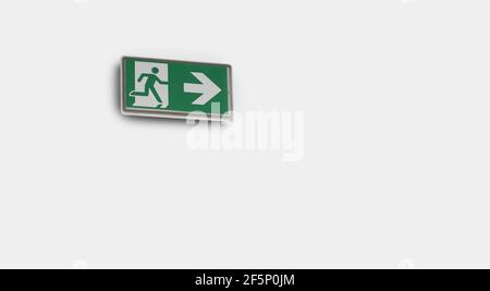 Emergency exit sign on the white wall background Stock Photo