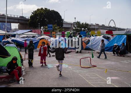 Tijuana, Mexico. 27th Mar, 2021. Children play at El Chaparral plaza in Tijuana, Mexico on Friday, March 26, 2021. Hundreds of asylum seekers have set up tents near the port of entry in hopes of being able to seek asylum in the United States. Photo by Ariana Drehsler/UPI Credit: UPI/Alamy Live News Stock Photo