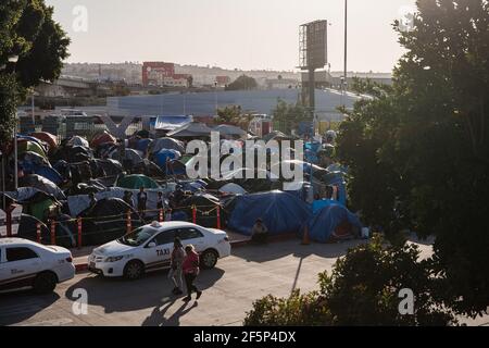 Tijuana, Mexico. 27th Mar, 2021. Hundreds of asylum seekers have set up tents by the port of entry at El Chaparral plaza in Tijuana, Mexico on Friday, March 26, 2021. Photo by Ariana Drehsler/UPI Credit: UPI/Alamy Live News Stock Photo