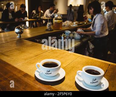 Tokyo, Japan - Two cups of coffee at Cafe Kitsune located near Omotesandō and Aoyama. Interior design inspired by the Edo period. Stock Photo