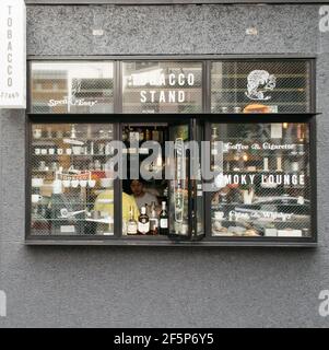 Minato, Tokyo, Japan - Small tobacco stand selling coffee, whiskey, and cigarette. Window of the cafe located in Aoyama. Stock Photo
