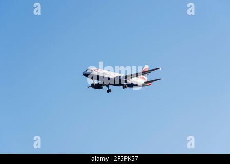 British Airways Airbus A320 200 jet airliner plane G-EUUI on finals to land at London Heathrow Airport UK, in large area of blue sky space. Air travel Stock Photo