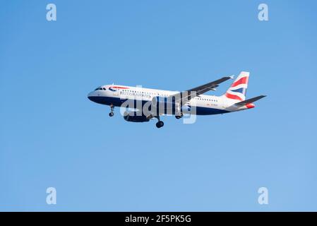 British Airways Airbus A320 200 jet airliner plane G-EUUI on finals to land at London Heathrow Airport UK, in large area of blue sky space. Air travel Stock Photo