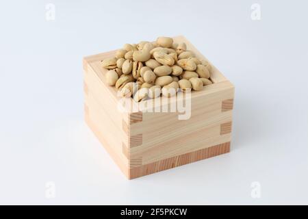parched soy beans in measuring box isolated on white background Stock Photo