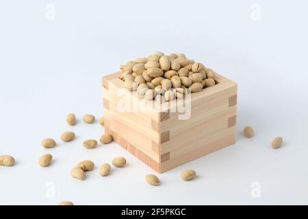 parched soy beans in measuring box isolated on white background Stock Photo