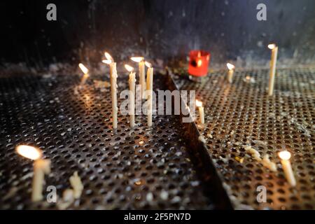 Details with candles lit inside an Christian Orthodox church for the living and for the dead. Stock Photo