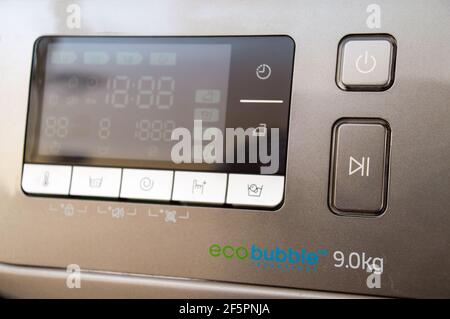 Washing machine control programming panel with round dial and buttons Stock Photo