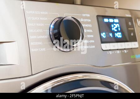 Washing machine control programming panel with round dial and buttons Stock Photo