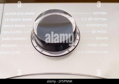 Washing machine control programming panel with round dial and buttons Stock Photo