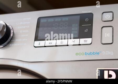 Washing machine control programming panel with round dial and buttons Stock Photo