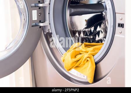 Clothes in washing machine for laundry at home Stock Photo