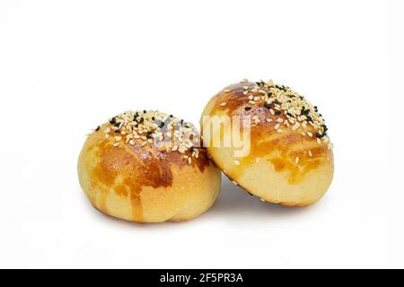 Two freshly baked buns with sesame and black cumin on isolated white background Stock Photo