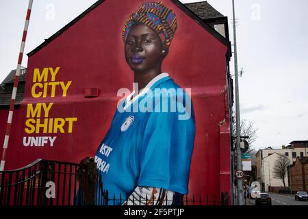 Cardiff, UK. 27th Mar, 2021. A Mural by artist Yusuf Ismail of a Pregnant Women in a Cardiff City football Shirt has appeared on the side of Mischiefs Cafe & Bar in Cardiff Bay, Wales pictured on the 27th March 2021. Credit: Lewis Mitchell/Alamy Live News Stock Photo