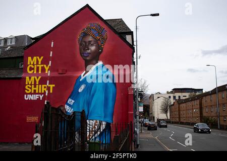 Cardiff, UK. 27th Mar, 2021. A Mural by artist Yusuf Ismail of a Pregnant Women in a Cardiff City football Shirt has appeared on the side of Mischiefs Cafe & Bar in Cardiff Bay, Wales pictured on the 27th March 2021. Credit: Lewis Mitchell/Alamy Live News Stock Photo