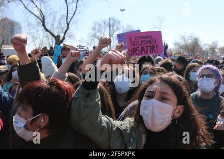 Istanbul, Turkey. 27th Mar, 2021. Protesters hold up their fists during the demonstration.People gathered in Kadikoy to protest against Turkey's withdrawal from Istanbul Convention. Istanbul Convention, signed by 45 countries and the European Union, requires the prevention of all kinds of violence against women, protection of victims of violence and punishment of criminals. (Photo by Hakan Akgun/SOPA Images/Sipa USA) Credit: Sipa USA/Alamy Live News Stock Photo