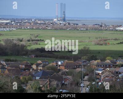 Minster on Sea, Kent, UK. 27th March 2021. Reuters has recently reported on how the 'Kent variant' of Covid-19 which has now spread around the globe, developed on the Isle of Sheppey, with high concentrations occuring within the island's prisons. Pic: a general view across the Isle of Sheppey from Minster on Sea, looking towards the principle town of Sheerness & Port of Sheerness. Credit: James Bell/Alamy Live News Stock Photo