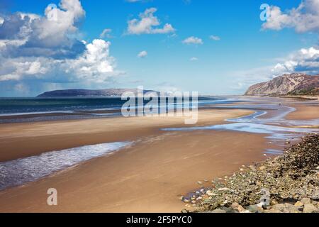 Penmaenmawr Beach, near the town of Penmaenmawr in North Wales, is a long sandy beach adjacent to the Menai Straits. Stock Photo
