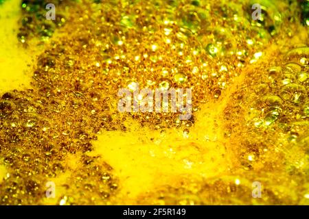 Golden foam. Background and texture concept. Close up of bubbling golden foam. Foam texture as background Stock Photo