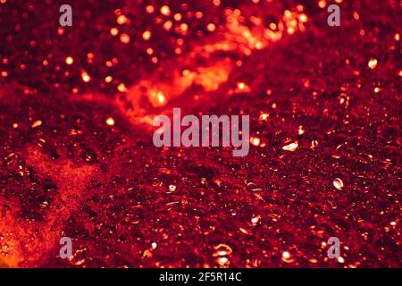 Burgundy foam. Foam texture as background. Background and texture concept. Close up of bubbling burgundy foam Stock Photo