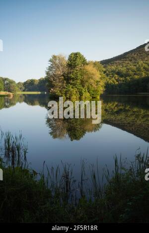 Flawless reflections of the small island at Abbott Lake with the Peaks of Otter of the Virginia Blue Ridge. Stock Photo