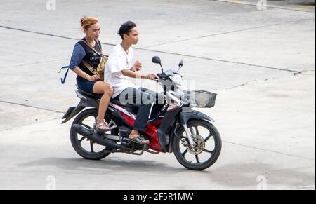 SAMUT PRAKAN, THAILAND, JUNE 26 2020, The pair rides on motorcycle at the street. Stock Photo