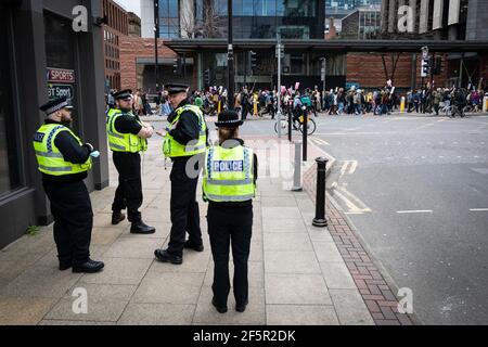 Manchester, UK. 27th Mar, 2021. The police watch as a 'Kill The Bill' demonstration marches past done Portland Street. People come out to the streets to protest against the new policing bill. The new legislation will give the police more powers to control protests. Credit: Andy Barton/Alamy Live News Stock Photo