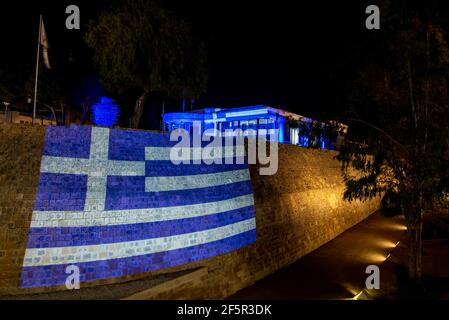 Flag of Greece illuminated in nicosia ancient wall and municipality building during the celebrations of Greek independence day Stock Photo
