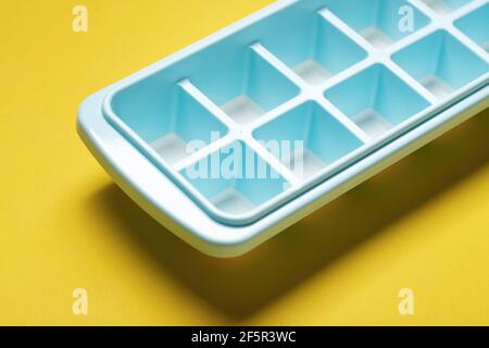 Blue plastic mold for making ice cubes for use in cocktails. Space for text. Stock Photo