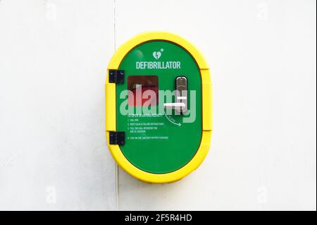 Defibrillator AED on wall in public space for emergency heart resuscitation Stock Photo