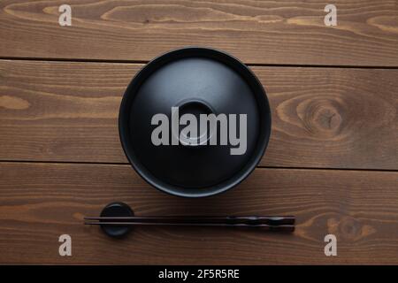 donburi rice bowl black isolated on wooden table Stock Photo