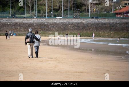couple walking on the beach Stock Photo